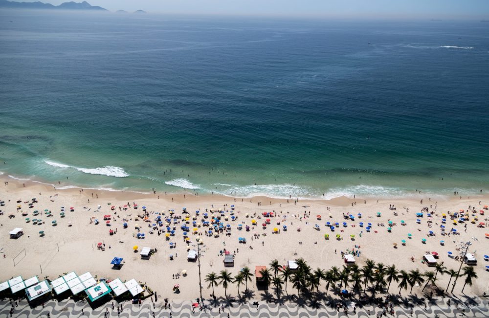An aerial shot of Copacabana beach in Rio de Janeiro Brazil crowded with people