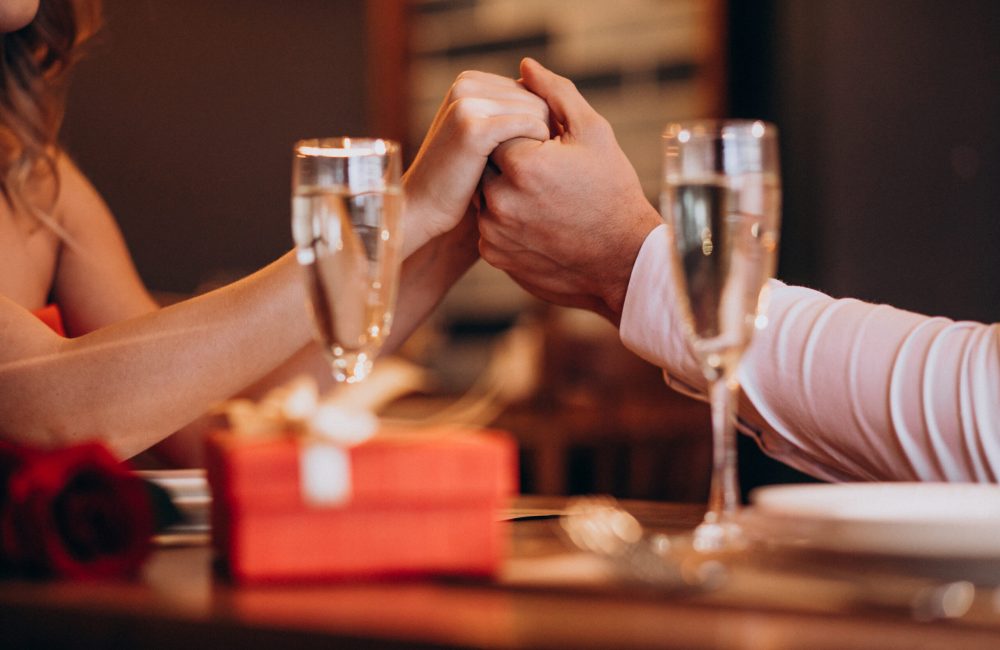 Couple holding hands on valentines evening in a restaurant
