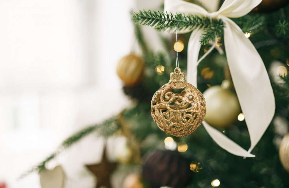 Christmas tree decorated with white and golden balls close up photo