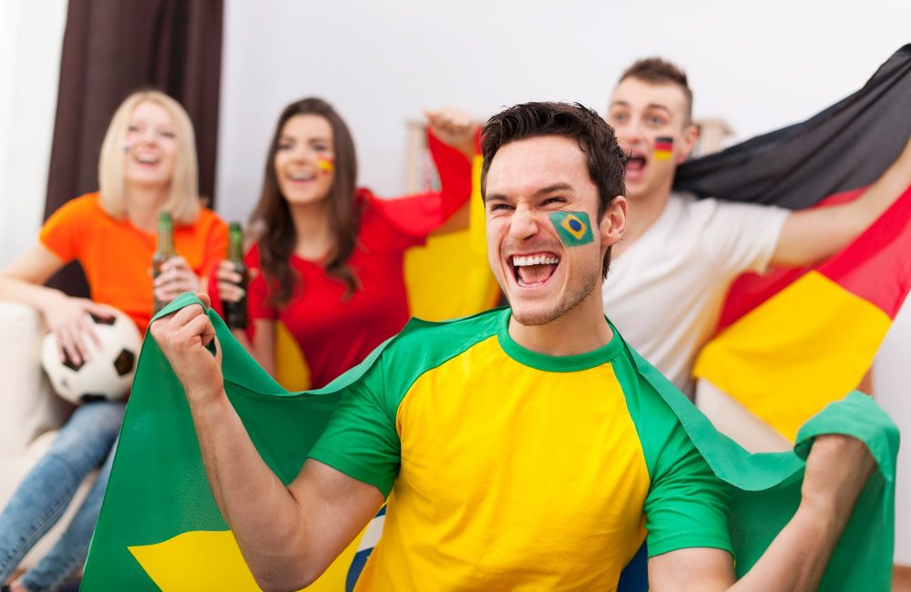 excited-brazilian-man-with-her-friends-cheering-football-match