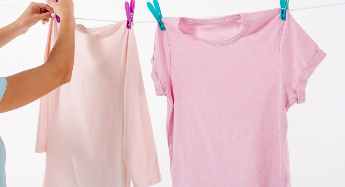 woman-fixing-t-shirts-on-clothesline-with-clothes-pins